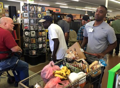 US Army Sgt. Mel Carry from the 301st Public Affairs Detachment, Army Reserve assists in delivering food to a needy local at a Mesa, Ariz. food bank.