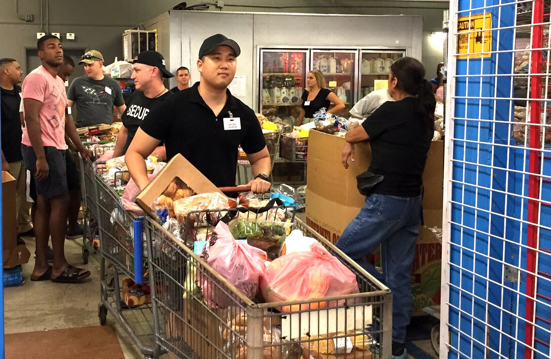 US Army 1st Lt. Aaron Bae from the 301st Public Affairs Detachment, Army Reserve prepares to assist with delivering food to needy locals at a Mesa, Ariz. food bank.
