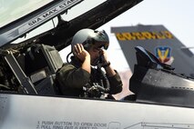 Capt. Justin Lee, 79th Fighter Squadron F-16 Fighting Falcon pilot, dons his gear during Red Flag 16-3 exercise at Nellis Air Force Base, Nevada, Monday, June 11, 2016. This year, 115 aircraft from 25 Department of Defense units will be operating at the Nevada Test and Training Range, the Air Force’s premier military training area with more than 15,000 square miles of airspace and 2.9 million acres of land. (U.S. Air Force photo/Tech. Sgt. Julius Delos Reyes)