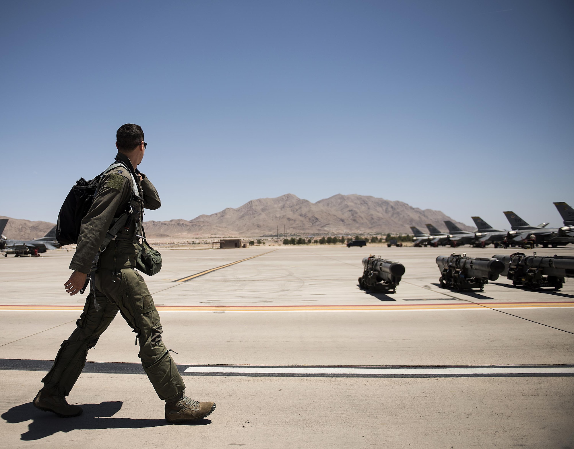Capt. Justin Lee looks out over the Nellis Air Force Base, Nevada flight line as he heads to his F-16 Fighting Falcon day one of Red Flag, July 11, 2016. Lee is from Shaw Air Force Base's 79th Fighter Squadron. (U.S. Air Force photo/Tech. Sgt. David Salanitri)  