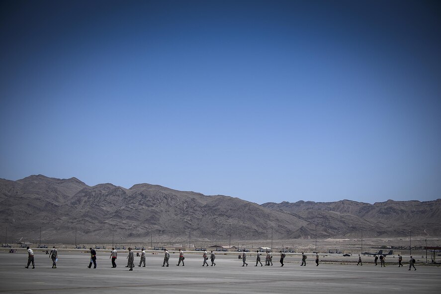 Airmen from the 79th Fighter Squadron from Shaw Air Force Base, Nevada, conduct a walk searching for possible foreign object debris at Nellis Air Force Base, Nevada before the first air missions take off day 1 of Red Flag.  Red Flag 16-3 is one of four Red Flag exercises at Nellis. (U.S. Air Force photo/Tech. Sgt. David Salanitri)