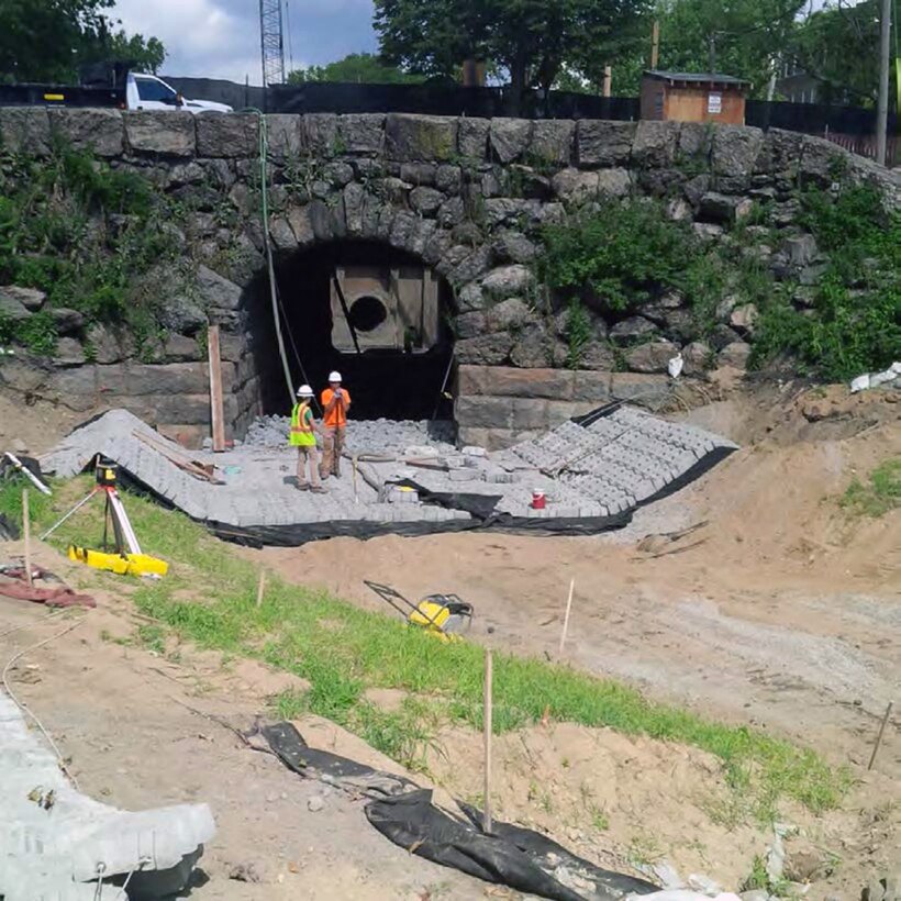Sediment is removed from inside the culvert and installation of the articulated concrete blocks (ACB) has begun – late August 2015.
