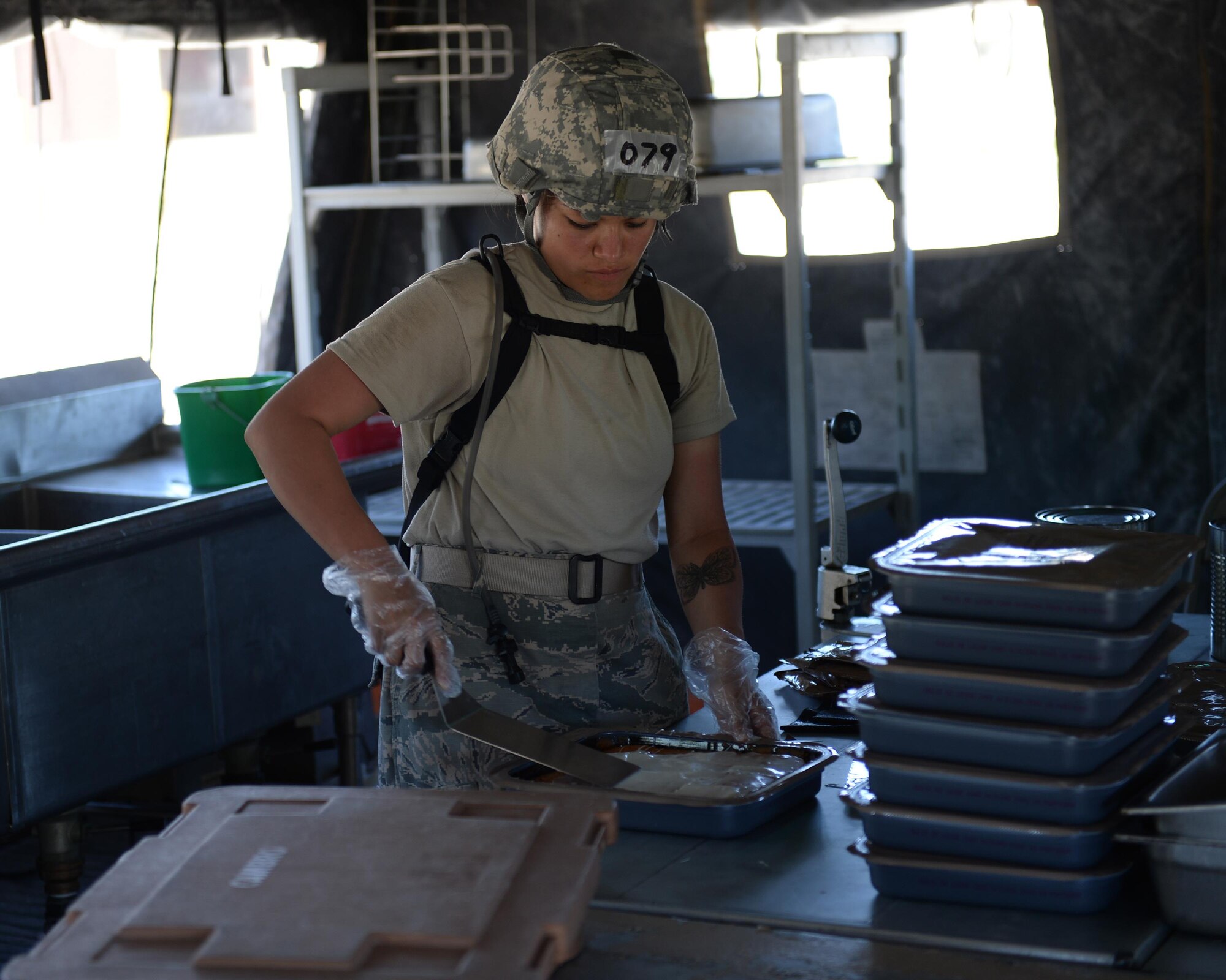 U.S. Air Force Airman 1st Class Nicolle Vella, 104th Fighter Wing services specialist, prepares food for students at the Silver Flag exercise site at Tyndall Air Force Base, Fla., June 23, 2016. The services students are from Barnes Air National Guard Base, Mass., and were tasked with setting up a working kitchen on-site and providing freshly made food for all the students going through the course. (U.S. Air Force photo by Airman 1st Class Cody R. Miller/Released)