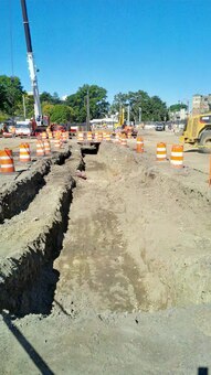 Pre-excavation in the former Sears Parking Lot for the river diversion steel sheeting line – note the removal of the temporary utilities line – early October 2015.