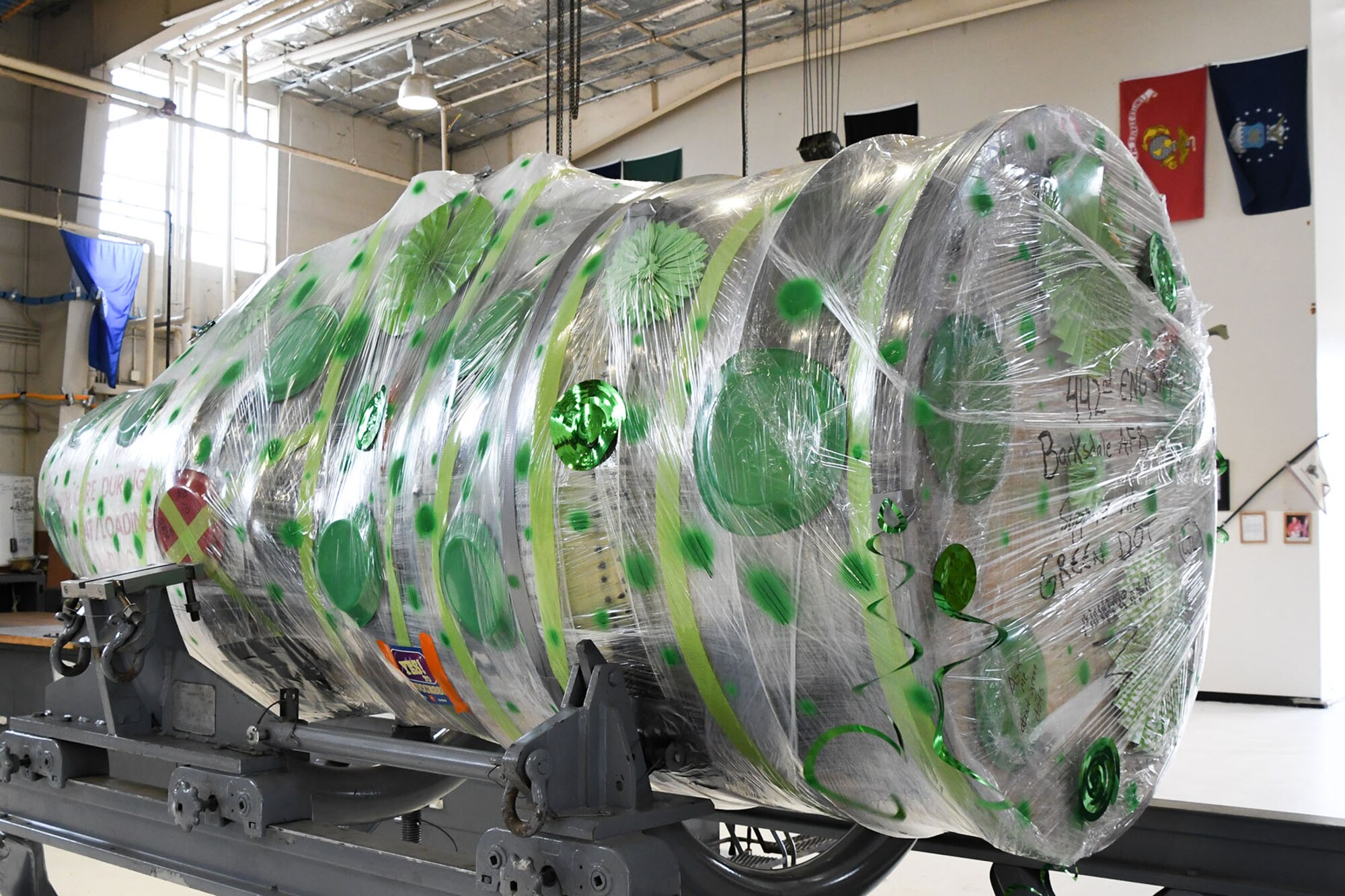 Airmen assigned to the 442nd Maintenance Squadron Operating Location Alpha display their support for Green Dot by decorating the wrapping with green dots around a General Electric TF34 turbofan engine at Barksdale Air Force Base, La., July 6, 2016. The Green Dot initiative, founded by psychologist Dr. Dorothy Edwards, specifically aims to empower people to demonstrate, in ways large and small, their individual commitment to ending sexual violence. (Information in this caption provided by the Air Force Times, Courtesy photo)
