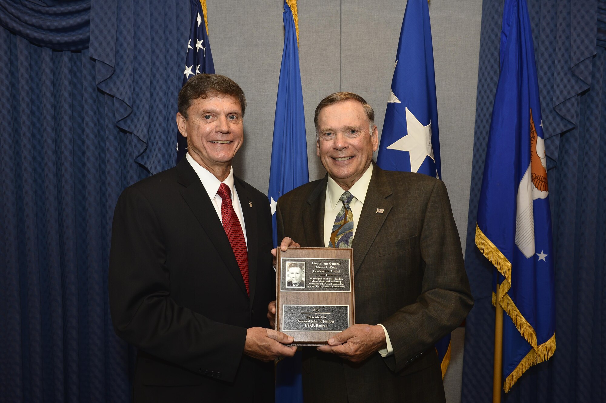 Kevin Williams, the director of Air Force Studies, Analyses and Assessments, presents the Lt. Gen. Glenn A. Kent Leadership Award to former Air Force Chief of Staff Gen. John P. Jumper at the Pentagon on June 11, 2016. The Kent award recognizes influential leaders who’ve had substantive analytic responsibilities during their career and whose vision and leadership have had a significant and lasting effect on the achievements of Air Force analysis. (U.S. Air Force photo/Tech. Sgt. Anthony Nelson Jr.)