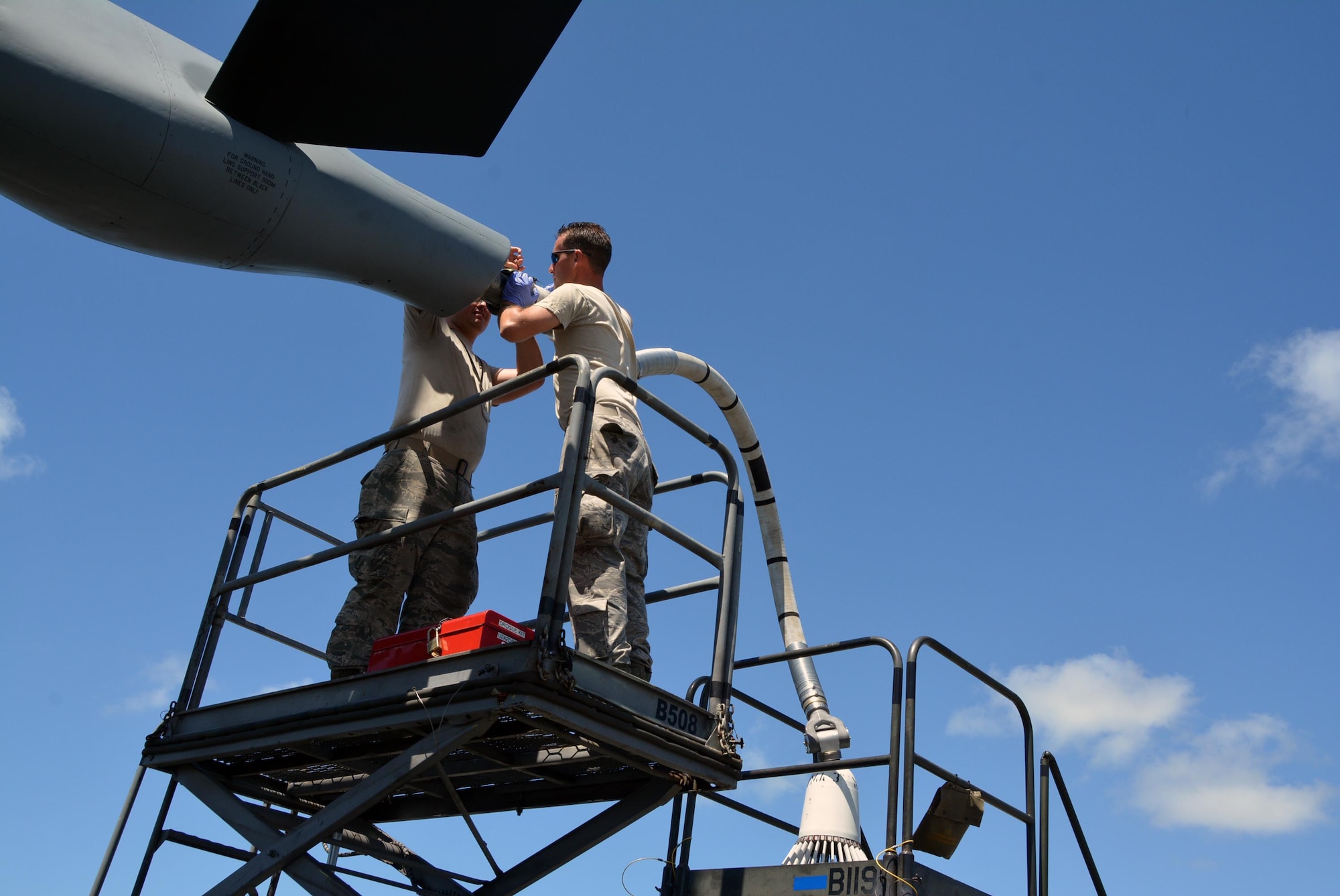 Staff Sgt. James Andrus and Senior Airman Travis Krause, U.S. Air Force crew chiefs with the 507th Aircraft Maintenance Squadron at Tinker Air Force Base, Okla., connect a drogue adapter to a KC-135R Stratotanker in order to connect a drogue. A drogue is used in air-to-air refueling. The probe and drogue method of refueling uses a trailing hose with a basket on the end. Pilots guide a probe on their aircraft into the basket to connect with the hose. Air Force helicopters, and all Navy and Marine Corps aircraft refuel using the hose-and-drogue for air-to-air refueling. Andrus, Krause and other Citizen Airmen are participating in Rim of the Pacific exercise 2016. (U.S. Air Force photo/Master Sgt. Grady Epperly/Released) 