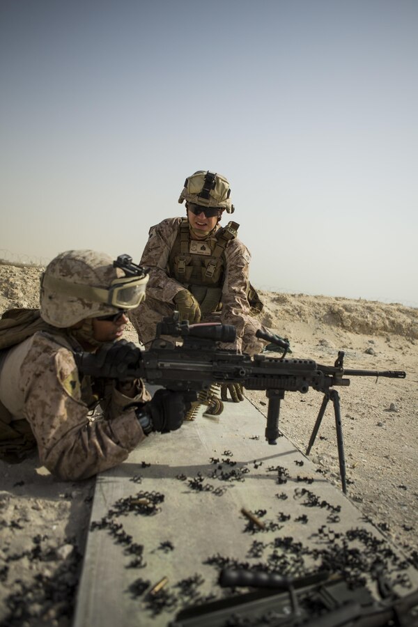 U.S. Marine Corps Sgt. Ryan Benson (center), a squad leader with Company C, Marine Wing Support Squadron 373, Special Purpose Marine Air Ground Task Force - Crisis Response - Central Command 16.2, acts as a primary safety officer for U.S. Marines operating M249 light machine guns during a familiarization range at an undisclosed location in Southwest Asia, June 8, 2016. SPMAGTF-CR-CC is forward deployed in several host nations, with the ability to respond to a variety of contingencies rapidly and effectively. (U.S. Marine Corps photo by Sgt. Donald Holbert/ Released)