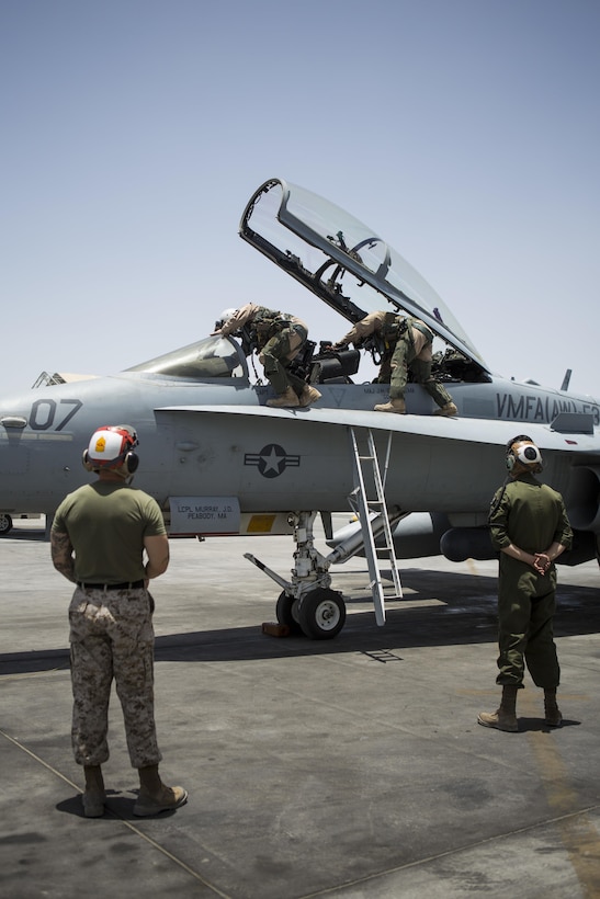 U.S. Marine Corps pilots with Marine All-Weather Fighter Attack Squadron 533, Special Purpose Marine Air Ground Task Force - Crisis Response - Central Command 16.2, exit an F/A-18D Hornet after returning to an undisclosed location in Southwest Asia, June 9, 2016. VMFA(AW)-533 operates and conducts strikes as part of the Aviation Combat Element of SPMAGTF-CR-CC in support of Operation Inherent Resolve, the operation to eliminate the ISIL terrorist group and the threat they pose to Iraq, Syria, and the wider international community. (U.S. Marine Corps photo by Sgt. Donald Holbert/ Released)
