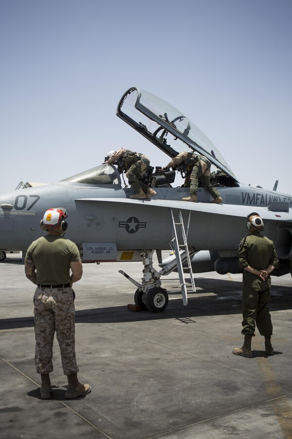 U.S. Marine Corps pilots with Marine All-Weather Fighter Attack Squadron 533, Special Purpose Marine Air Ground Task Force - Crisis Response - Central Command 16.2, exit an F/A-18D Hornet after returning to an undisclosed location in Southwest Asia, June 9, 2016. VMFA(AW)-533 operates and conducts strikes as part of the Aviation Combat Element of SPMAGTF-CR-CC in support of Operation Inherent Resolve, the operation to eliminate the ISIL terrorist group and the threat they pose to Iraq, Syria, and the wider international community. (U.S. Marine Corps photo by Sgt. Donald Holbert/ Released)