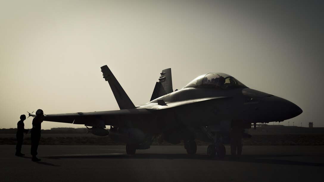 U.S. Marines with Marine All-Weather Fighter Attack Squadron 533, Special Purpose Marine Air Ground Task Force - Crisis Response - Central Command 16.2, arm ordnance on an F/A-18D Hornet at an undisclosed location in Southwest Asia, June 9, 2016. VMFA(AW)-533 operates and conducts strikes as part of the Aviation Combat Element of SPMAGTF-CR-CC in support of Operation Inherent Resolve, the operation to eliminate the ISIL terrorist group and the threat they pose to Iraq, Syria, and the wider international community. (U.S. Marine Corps photo by Sgt. Donald Holbert/ Released)