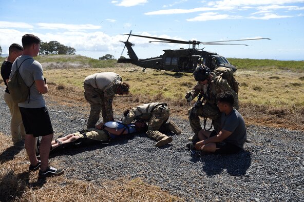 Special Tactics Airmen from the 320th Special Tactics Squadron prepare to load simulated injured civilians on the UH-60 Blackhawk during a humanitarian assistance and disaster response scenario as part of Rim of the Pacific (RIMPAC) 2016, Pohakuloa Training Area, Hawaii, July 10, 2016.  RIMPAC 2016 is the 25th exercise in the series that began in 1971.(U.S. Air Force photo by 2nd Lt. Jaclyn Pienkowski/Released)