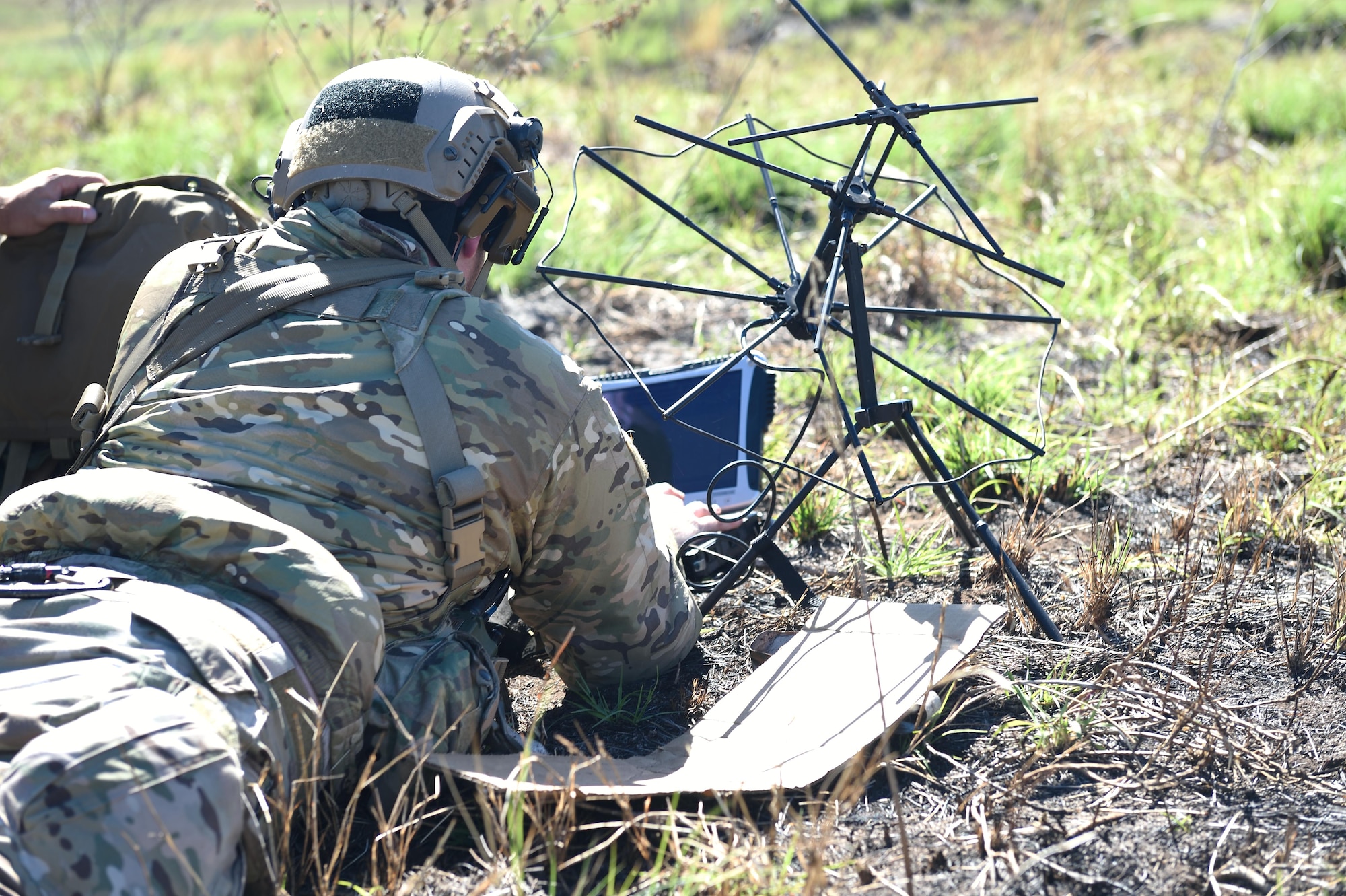 An Air Force combat controller with the 320th Special Tactics Squadron sends data over a network using a satellite communication antenna and a laptop during a humanitarian assistance and disaster response scenario as part of Rim of the Pacific (RIMPAC) 2016, Pohakuloa Training Area, Hawaii, July 10, 2016. RIMPAC offers the 320th STS and III Marine Expeditionary Force an opportunity to team up and practice their unique skills to strengthen their partnership in order to respond to crises quickly. (U.S. Air Force photo by 2nd Lt. Jaclyn Pienkowski/Released)