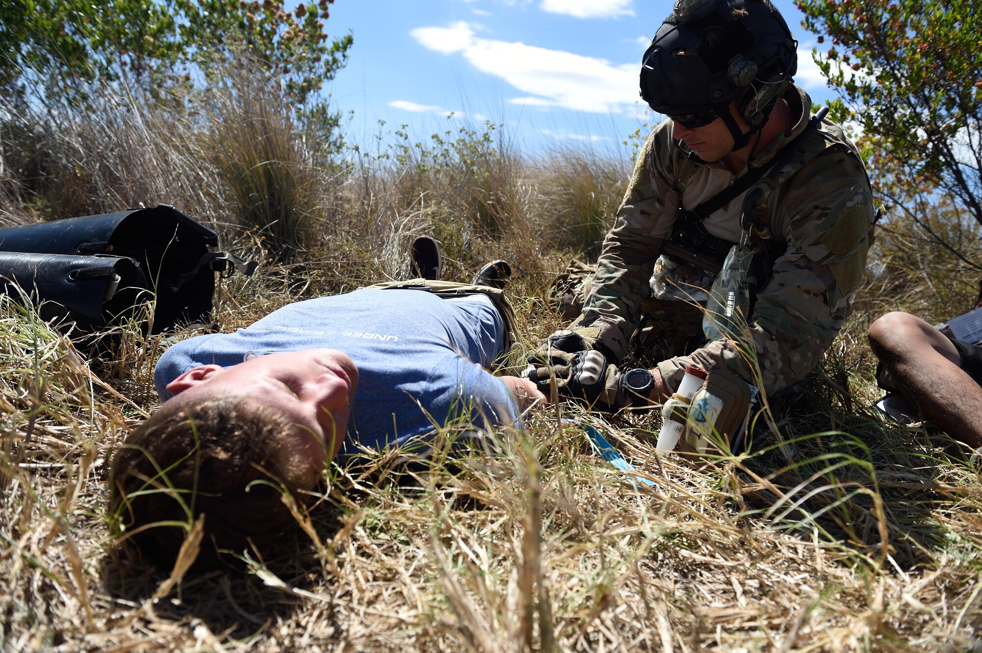 An Air Force pararescueman with the 320th Special Tactics Squadron provides emergency trauma medical care to a citizen who was injured in a simulated earthquake during a humanitarian assistance and disaster response scenario as part of Rim of the Pacific 2016, Pohakuloa Training Area, Hawaii, July 10, 2016. The world's largest international maritime exercise, this year is the 25th exercise in the series that began in 1971.(U.S. Air Force photo by 2nd Lt. Jaclyn Pienkowski/Released)