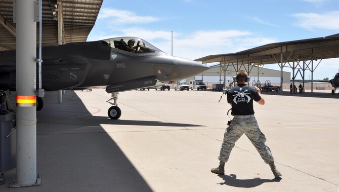 Staff Sgt. Jordon Tuck, crew chief in the 419th Maintenance Group, directs an F-35A as it taxies to the runway here July 9. This weekend marks the first time reservists in the 419th Fighter Wing conducted F-35 operations and maintenance independent of their active duty counterparts. (U.S. Air Force photo/Staff Sgt. Christina Judd)