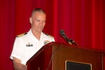 Navy Capt. Harry Thetford, commander of Defense Logistics Agency Distribution Norfolk, Va., speaks to newly-graduated Navy Junior Reserve Officer Training Corps students in the Norfolk area.