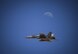 An EA-18G Growler takes off for a training mission as part of Red Flag 16-3 while the moon shines in the background at Nellis Air Force Base, Nevada, July 11, 2016. Red Flag 16-3 is focusing on integrating air, space and cyberspace. (U.S. Air Force photo/Tech Sgt. David Salanitri)