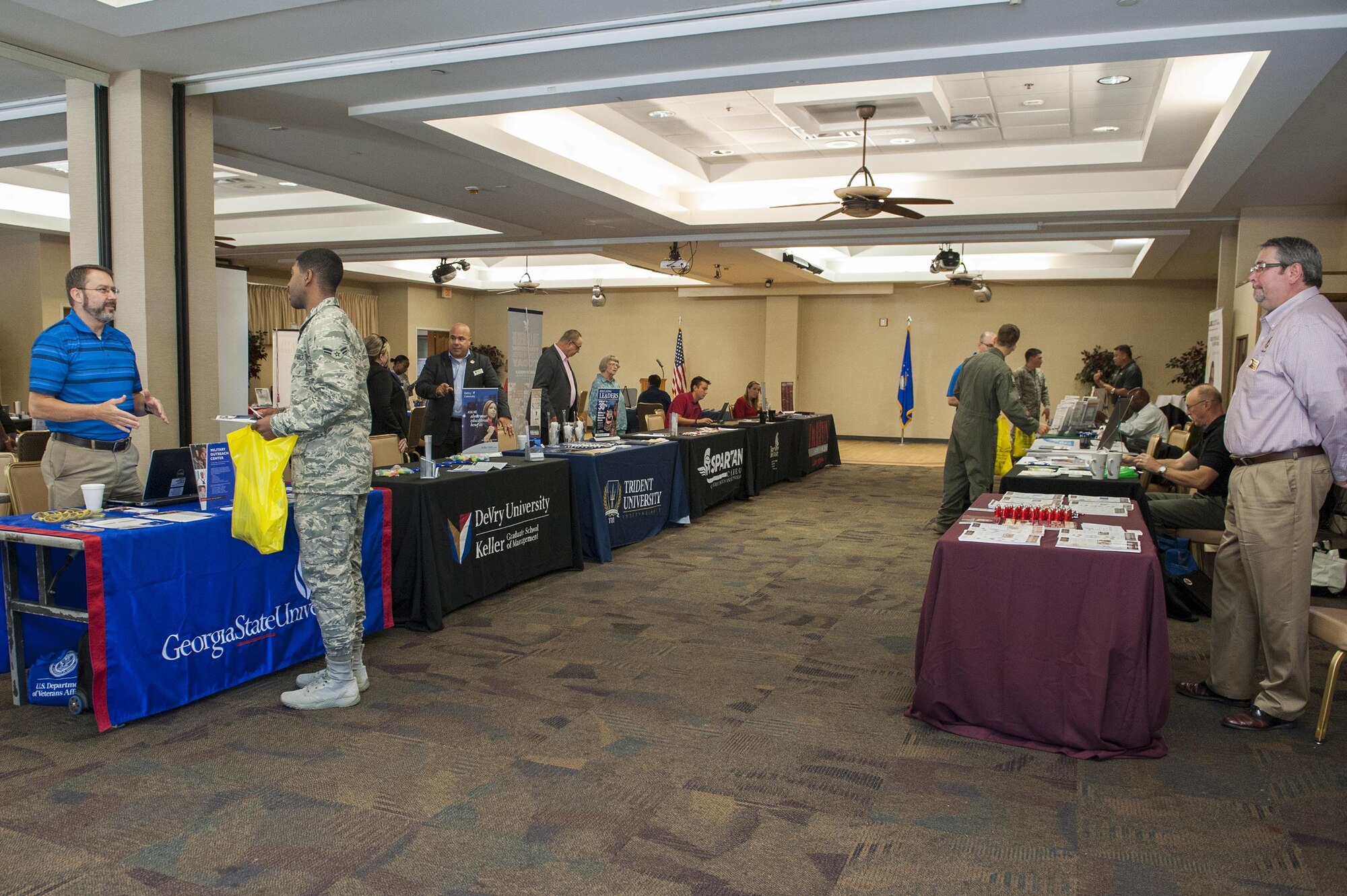 Education representatives and attendees congregate during the National Education Fair, July 13, 2016, at Moody Air Force Base, Ga. The Information Learning Center hosted the annual event for all Moody Airmen, spouses, retirees and civilians who wish to further their education. (U.S. Air Force photo by Airman 1st Class Lauren M. Hunter)