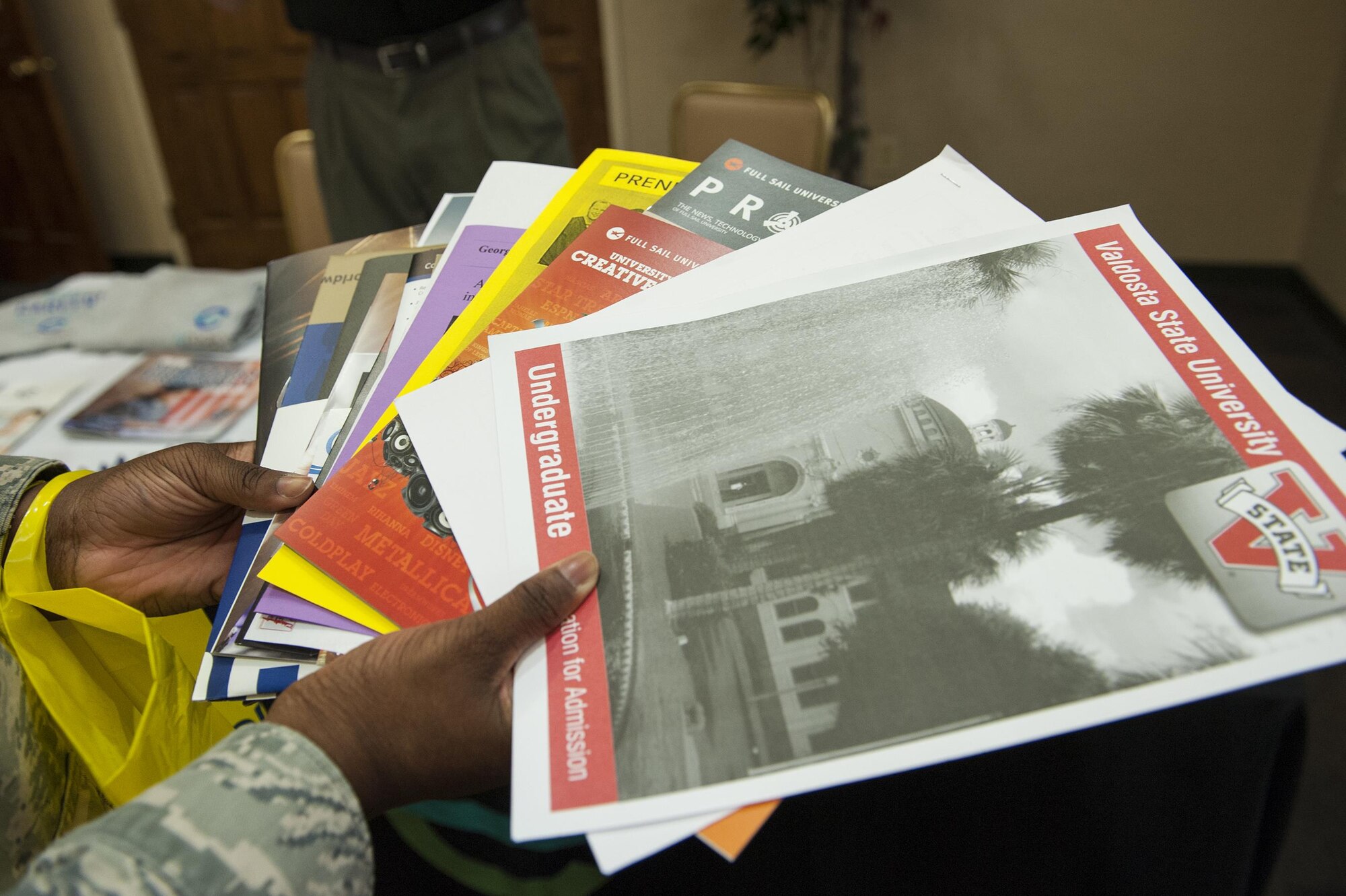 U.S. Air Force Airman Stacy Thomas, 23d Aircraft Maintenance Squadron administrator, holds brochures from various institutions during the National Education Fair, July 13, 2016, at Moody Air Force Base, Ga. Airmen in attendance received information regarding tuition assistance programs and the Community College of the Air Force degree program. (U.S. Air Force photo by Airman 1st Class Lauren M. Hunter)