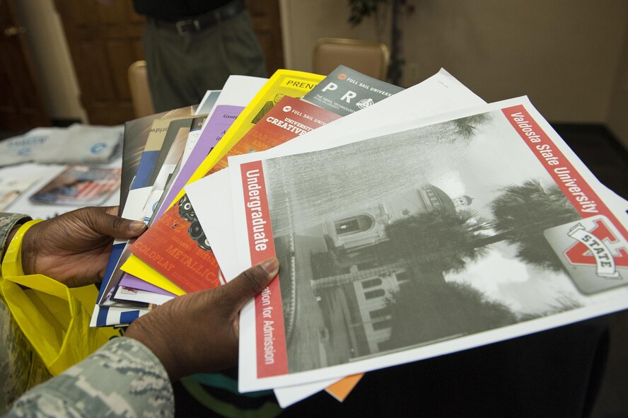 U.S. Air Force Airman Stacy Thomas, 23d Aircraft Maintenance Squadron administrator, holds brochures from various institutions during the National Education Fair, July 13, 2016, at Moody Air Force Base, Ga. Airmen in attendance received information regarding tuition assistance programs and the Community College of the Air Force degree program. (U.S. Air Force photo by Airman 1st Class Lauren M. Hunter)
