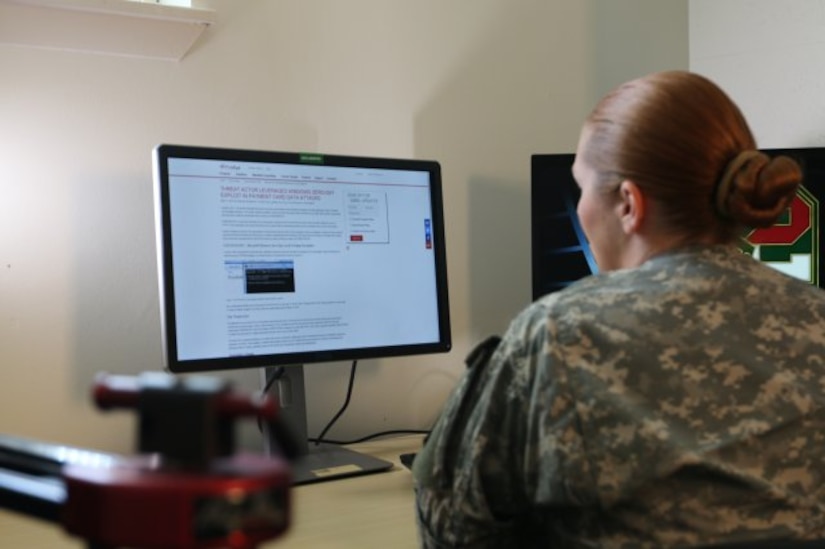 Staff Sgt. Lydia M. Seaborn, 335th Signal Command (Theater) Cyber Brigade, Army Reserve Cyber Operations Group, National Capital Region Cyber Protection Center, demonstrates cyber operations capabilities. (Photo Credit: Mike Milord)