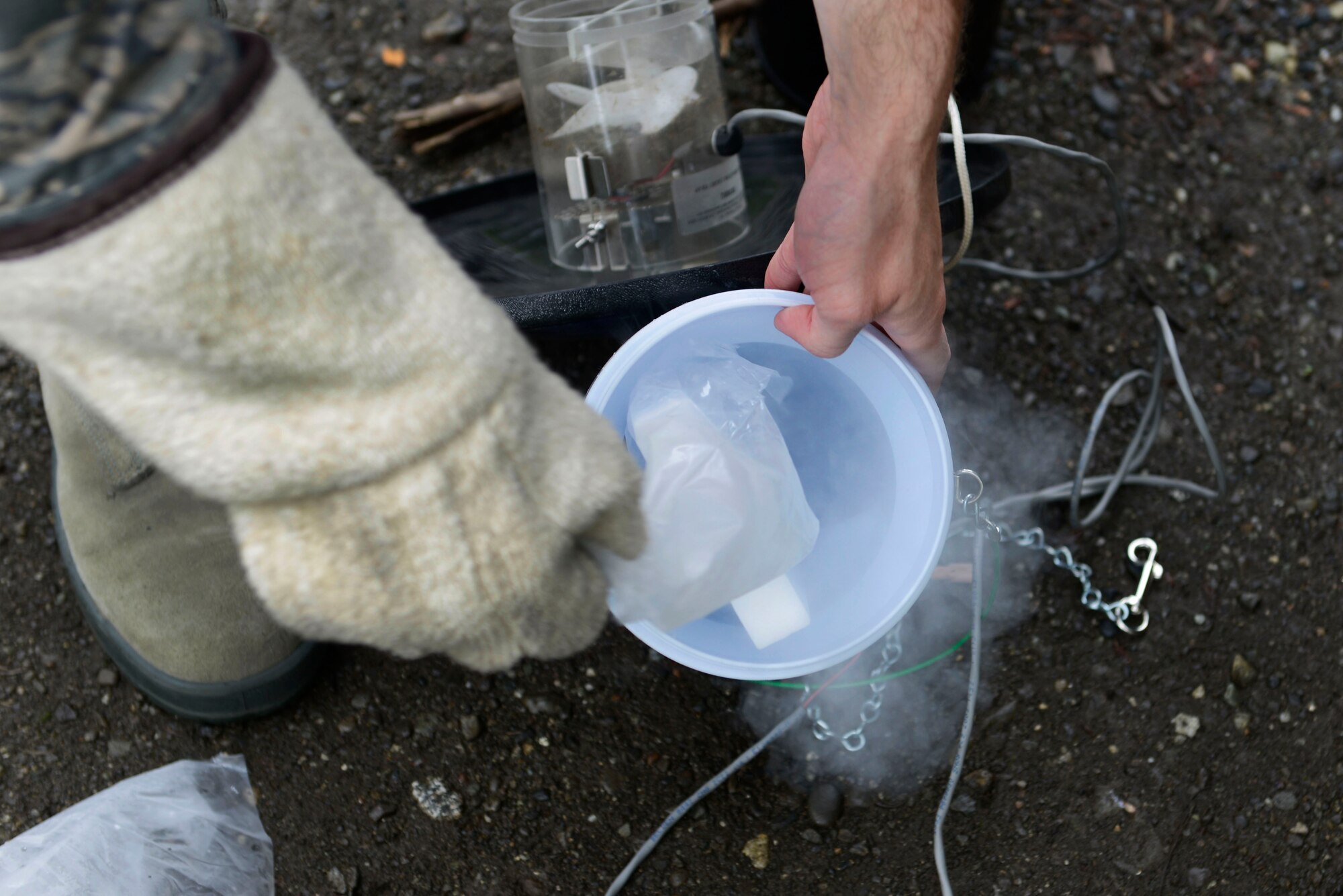 Airman 1st Class Brendan Rapp, 673d Aerospace Medical Squadron public health technician, places dry ice in a miniature light trap at Joint Base Elmendorf-Richardson, Alaska, July 6, 2016. According to the World Health Organization, mosquitoes are the greatest menace when it comes to disease-transmitting insects. They are responsible for several million deaths and hundreds of millions of cases every year involving malaria, dengue and yellow fever. (U.S. Air Force photo by Airman 1st Class Valerie Monroy)