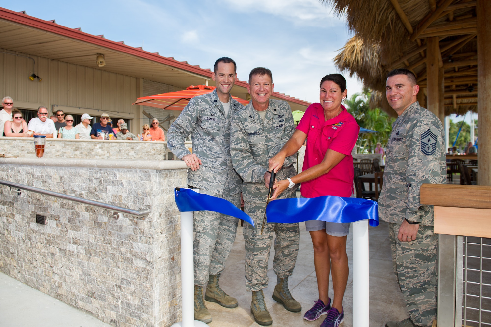 Lt. Col. Paul Somers, 45th Force Support Squadron commander, Brig. Gen. Wayne Monteith, 45th Space Wing commander, Leiane Roche, 45th FSS Marina manager, and Chief Master Sgt. Jason Lamoureux, 45th SW command chief, cut a ribbon to the renovated Tiki Deck July 12, 2016, at the Marina at Patrick Air Force Base, Fla. During the six-month renovation several improvements took place, which improved the quality of life here for Airmen and their families. (U.S. Air Force photo/Benjamin Thacker)  
