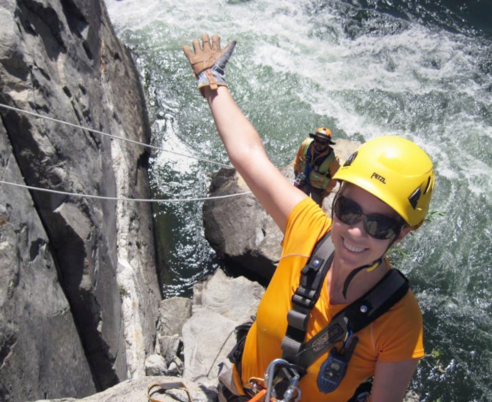 Coralie Wilhite, a geological engineer for the U.S. Army Corps of Engineers Sacramento District, rappels down a rock face along the bank of the American River near Folsom Dam to mark rock bolt anchor locations as part of the Joint Federal Project.