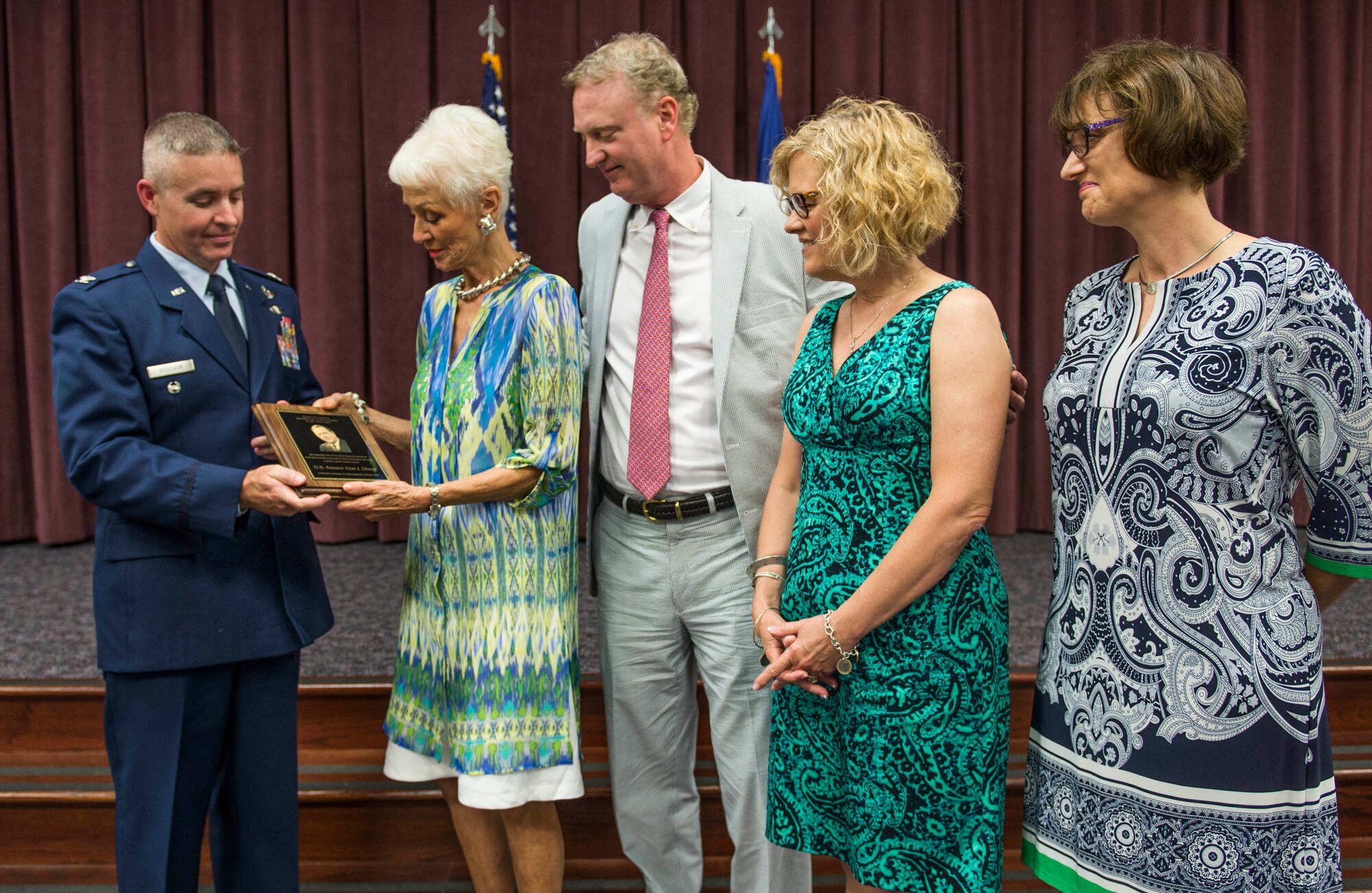 Col. Chris Buschur, 375th Mobility Wing vice commander, presents a plaque to the family of former Ill. Sen. Alan J. Dixon at Scott Air Force Base, Ill., July 8, 2016.  The visitor center was dedicated to Dixon, who gave 43 years of public service to Scott AFB and the state of Ill. (U.S. Air Force photo by Jodi Martinez/Released)