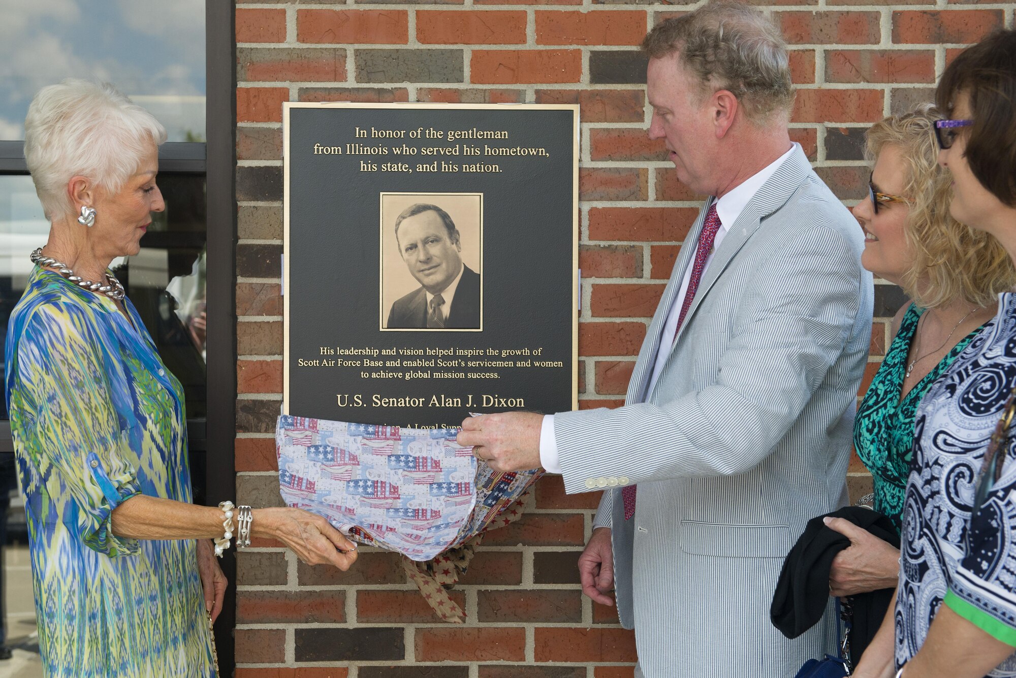 Ill. Sen. Alan J. Dixon’s wife, Jody Dixon, and son, Jeff Dixon, unveil a plaque during a dedication ceremony at the visitors control center at Scott Air Force Base, Ill., July 8, 2016. The visitor control center was dedicated to Dixon, who gave 43 years of public service to Scott AFB and the state of Ill.

(U.S. Air Force photo/ Senior Airman Kiana Brothers)
