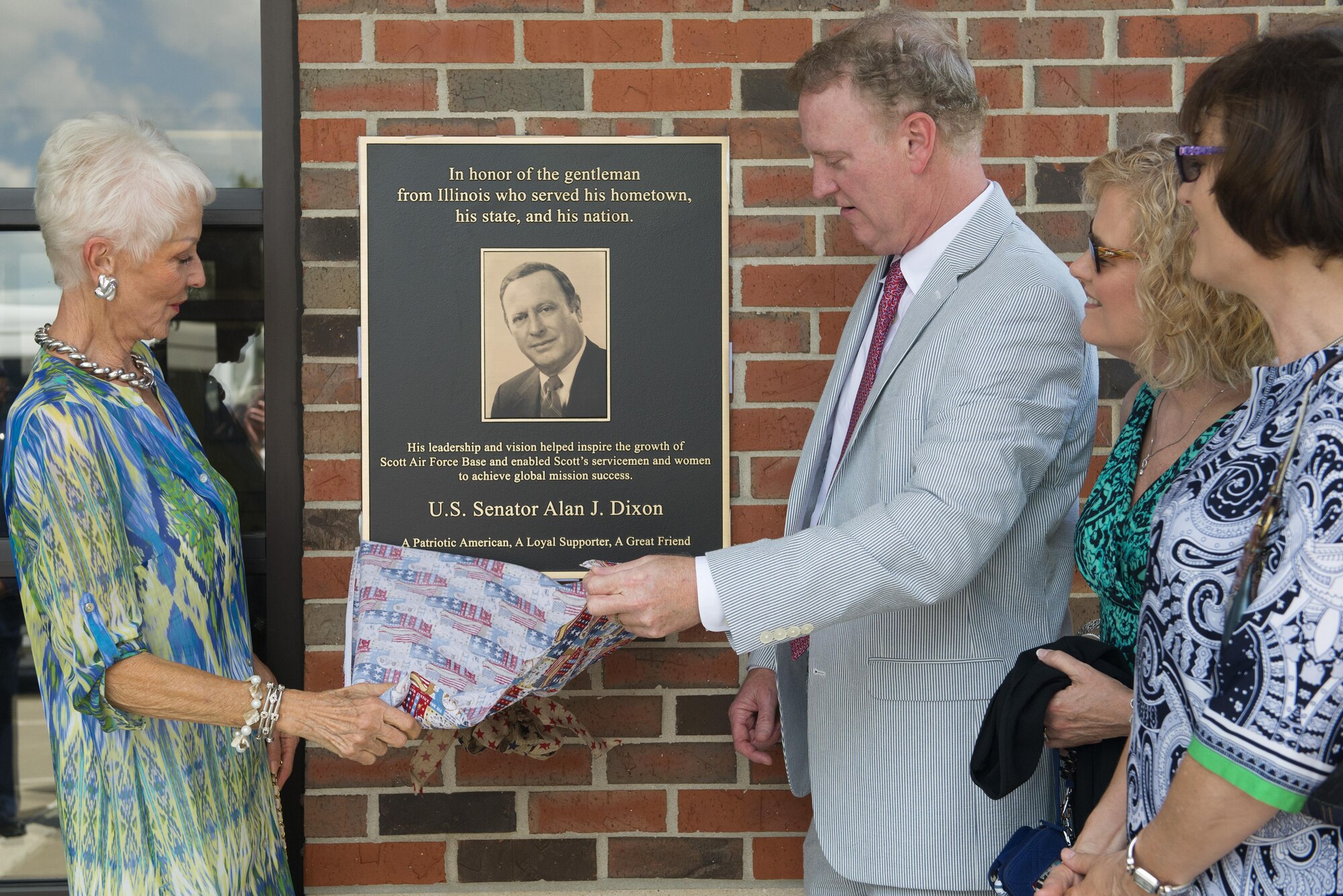 Ill. Sen. Alan J. Dixon’s wife, Jody Dixon, and son, Jeff Dixon, unveil a plaque during a dedication ceremony at the visitors control center at Scott Air Force Base, Ill., July 8, 2016. The visitor control center was dedicated to Dixon, who gave 43 years of public service to Scott AFB and the state of Ill.

(U.S. Air Force photo/ Senior Airman Kiana Brothers)
