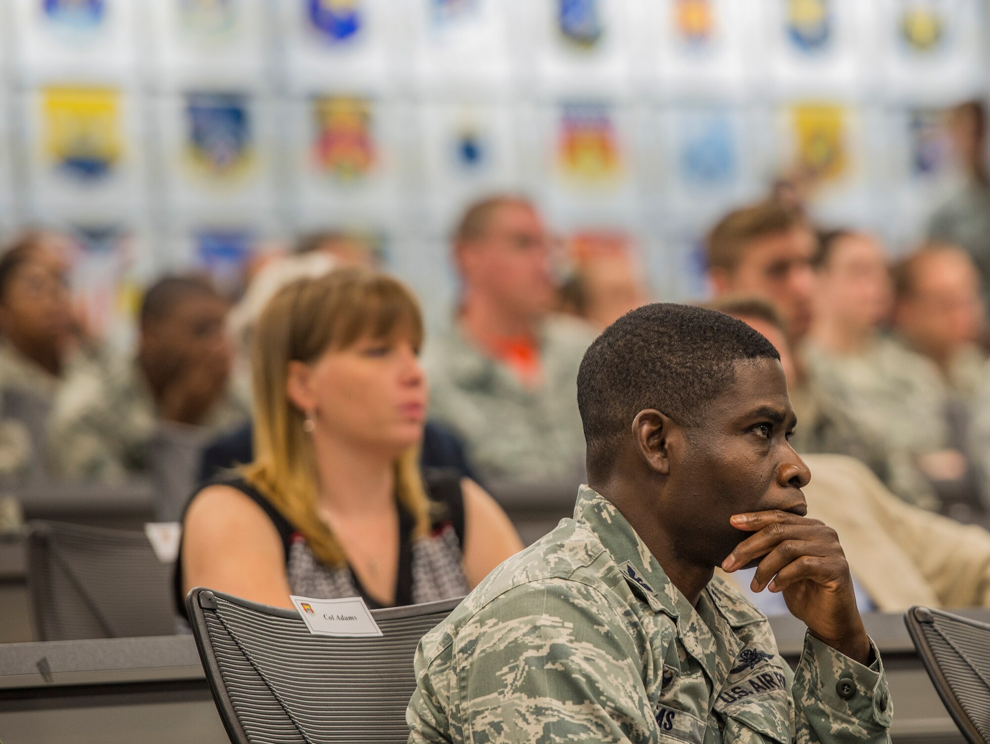 Col. Terrence Adams, 375th Communications Group Commander, listens during a the dedication for former Ill. Sen. Alan J. Dixon, who passed away in 2014, Scott Air Force Base, Ill, July 8, 2016. The visitor center was dedicated to Dixon, who gave 43 years of public service to Scott AFB and the state of Ill. (U.S. Air Force photo by Jodi Martinez/Released)