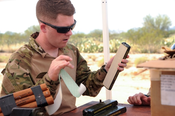 Staff Sgt. Michael McNally, a 355th Maintenance Group scheduler, removes the cover from an adhesive strip on a C4 plastic explosive block during an explosive ordnance disposal orientation at Davis-Monthan Air Force Base, Ariz., June 28, 2016. McNally has worked in the maintenance support field for the past eight years and hopes to switch to the EOD career field. (U.S. Air Force photo/Airman Nathan H. Barbour)