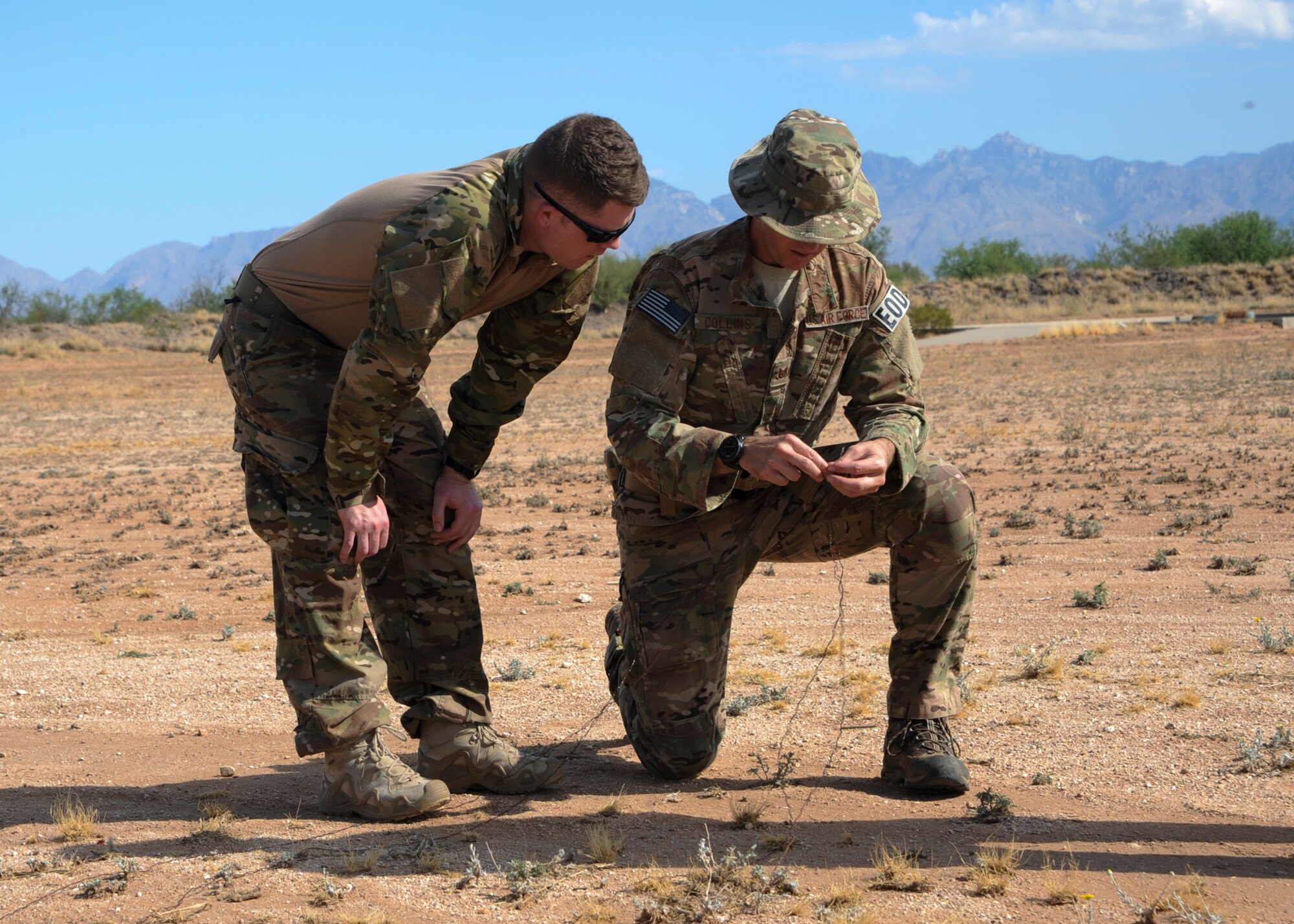 U.S. Air Force Tech. Sgt. David Collins, 355th Civil Engineer Squadron explosive ordnance disposal flight NCO in charge of training, explains the differences between two  ways to set up electric circuits for demolition to Staff Sgt. Michael McNally, 355th Maintenance Group scheduler, during an EOD immersion course at Davis-Monthan Air Force Base, Ariz., June 28, 2016. The immersion course serves a dual purpose of showing Airmen interested in retraining into EOD exactly what the specialty’s technicians do on a regular basis and also determines if the candidate is right for the job. (U.S. Air Force photo by Airman Nathan H. Barbour/Released)