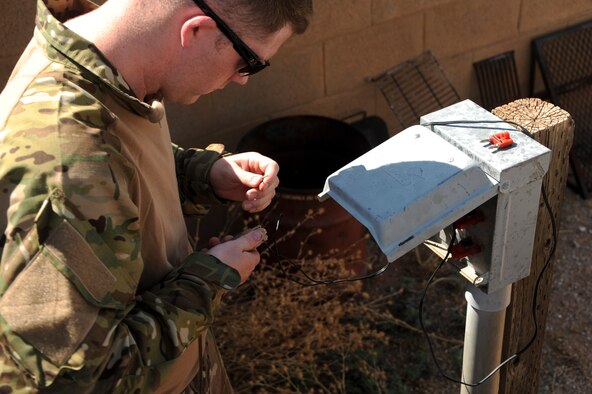 U.S. Air Force Staff Sgt. Michael McNally, 355th Maintenance Group scheduler, prepares to set off a charge during an explosive ordnance disposal immersion course at Davis-Monthan Air Force Base, Ariz., June 28, 2016. EOD technicians must be able to perform intricate procedures under high-stress conditions in all kinds of environments. (U.S. Air Force photo by Airman Nathan H. Barbour/Released)