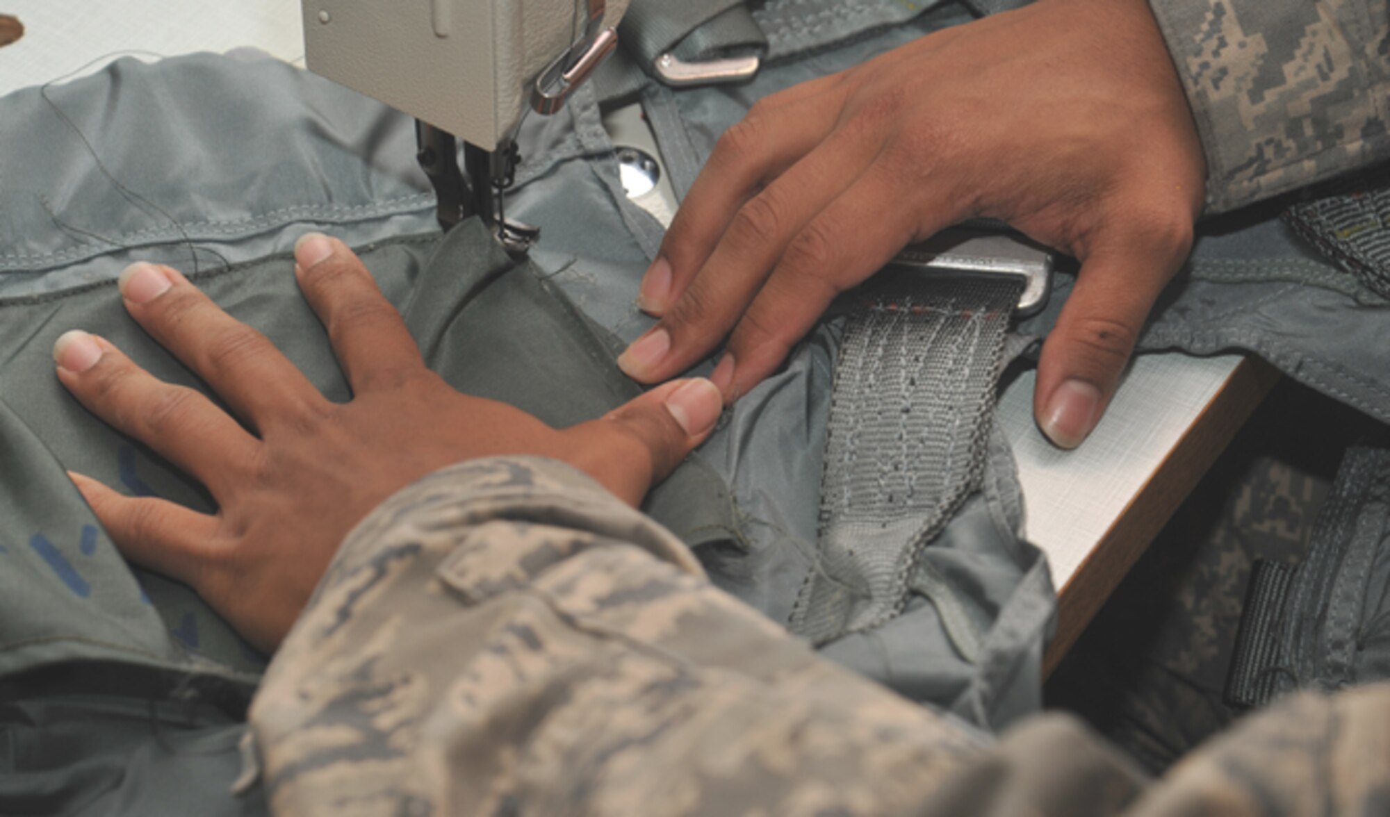 Senior Airman Kyle Boddie, 92nd Operations Support Squadron aircrew flight equipment journeyman, sews a pocket to a restrain harness July 7, 2016, at Fairchild Air Force Base, Wash. He was recently selected for the Thunderbirds team. (U.S. Air Force photo/Staff Sgt. Samantha Krolikowski)