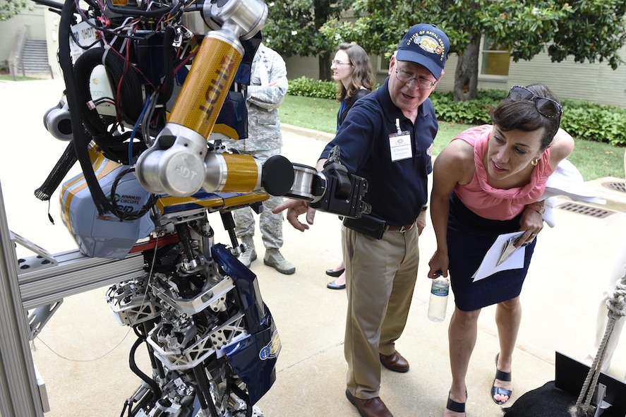 Dr. Tom McKenna, a program officer with the Office of Naval Research, talks to Dr. Janine Davidson, undersecretary of the Navy