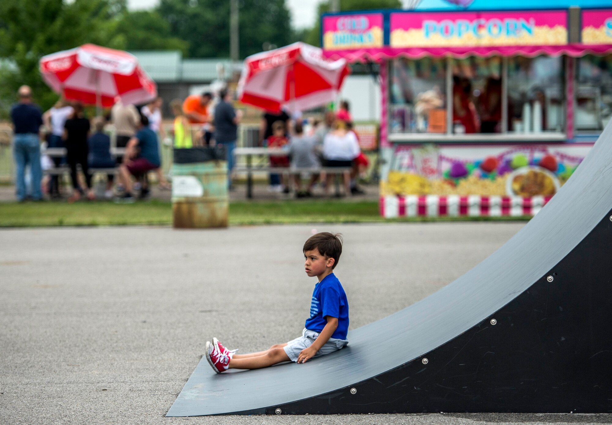 Despite the rainy weekend, thousands made it to the Old Fashioned 4th of July Celebration at Scheve Park, which featured carnival rides, live bands, food and craft booths, softball and kickball tournaments, games, raffles, poker and a fireworks show, Mascoutah, Ill., July 4, 2016.  Col. Terrence Adams, 375th Communications Group commander, spoke to spectators during the event in remembrance of Independence Day.  Following Adams, the U.S. Air Force Band of Mid-America’s Roots in Blue played favorite classics and current hits until fireworks lit the night sky. (U.S. Air Force photo by Staff Sgt. Jodi Martinez/Released)