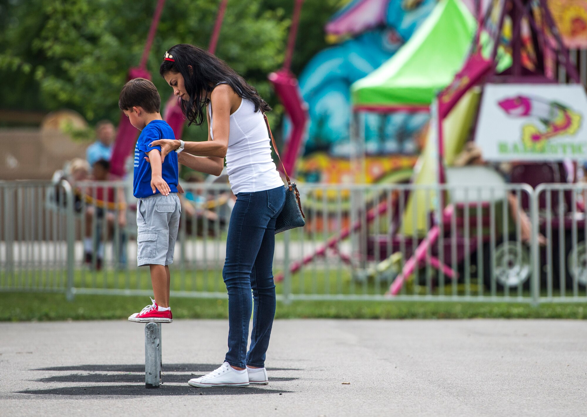 Despite the rainy weekend, thousands made it to the Old Fashioned 4th of July Celebration at Scheve Park, which featured carnival rides, live bands, food and craft booths, softball and kickball tournaments, games, raffles, poker and a fireworks show, Mascoutah, Ill., July 4, 2016.  Col. Terrence Adams, 375th Communications Group commander, spoke to spectators during the event in remembrance of Independence Day.  Following Adams, the U.S. Air Force Band of Mid-America’s Roots in Blue played favorite classics and current hits until fireworks lit the night sky. (U.S. Air Force photo by Staff Sgt. Jodi Martinez/Released)