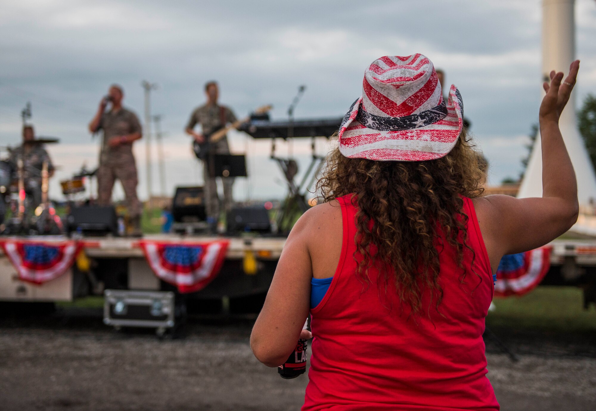 Despite the rainy weekend, thousands made it to the Old Fashioned 4th of July Celebration at Scheve Park, which featured carnival rides, live bands, food and craft booths, softball and kickball tournaments, games, raffles, poker and a fireworks show, Mascoutah, Ill., July 4, 2016.  Col. Terrence Adams, 375th Communications Group commander, spoke to spectators during the event in remembrance of Independence Day.  Following Adams, the U.S. Air Force Band of Mid-America’s Roots in Blue played favorite classics and current hits until fireworks lit the night sky. (U.S. Air Force photo by Staff Sgt. Jodi Martinez/Released)