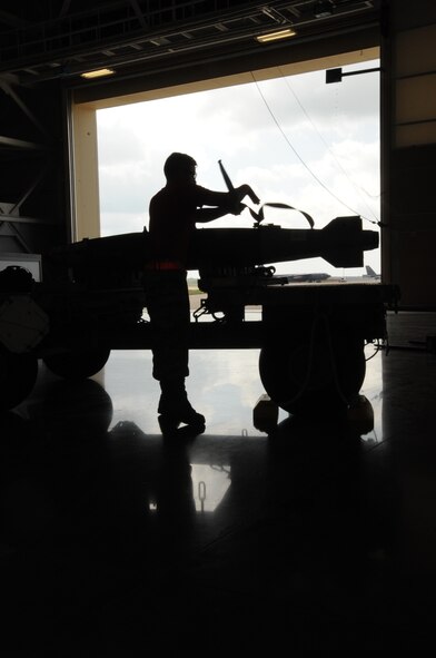 Senior Airman Erik Ortiz, 96th Aircraft Maintenance Unit Crew Cobra 1 member, inspects and secures munitions during a weapons load competition at Barksdale Air Force Base, La., July 8, 2016. One Crew per AMU are selected based on their loading stats for the quarter. (U.S. Air Force Photo/Airman Alexis C. Frost)