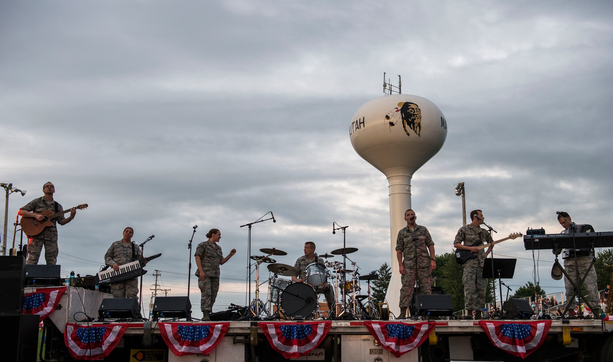 Despite the rainy weekend, thousands made it to the Old Fashioned 4th of July Celebration at Scheve Park, which featured carnival rides, live bands, food and craft booths, softball and kickball tournaments, games, raffles, poker and a fireworks show, Mascoutah, Ill., July 4, 2016.  Col. Terrence Adams, 375th Communications Group commander, spoke to spectators during the event in remembrance of Independence Day.  Following Adams, the U.S. Air Force Band of Mid-America’s Roots in Blue played favorite classics and current hits until fireworks lit the night sky. (U.S. Air Force photo by Staff Sgt. Jodi Martinez/Released)