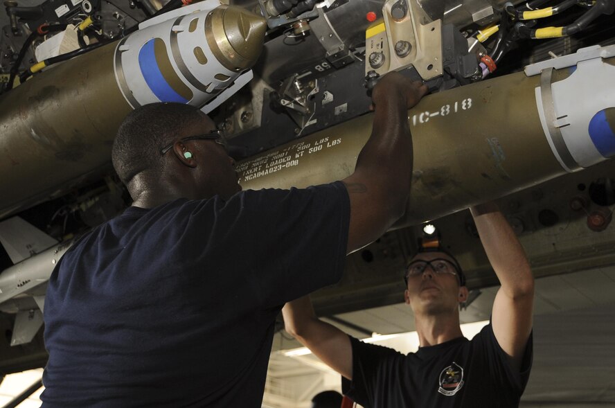 Weapons load crew team members from the 20th Aircraft Maintenance Unit load a Guided Bomb Unit-38 onto a B-52 Stratofortress at Barksdale Air Force Base, La., July 8, 2016. Each crew was tasked to load three units onto the B-52. (U.S. Air Force photo/Airman 1st Class Stuart Bright)