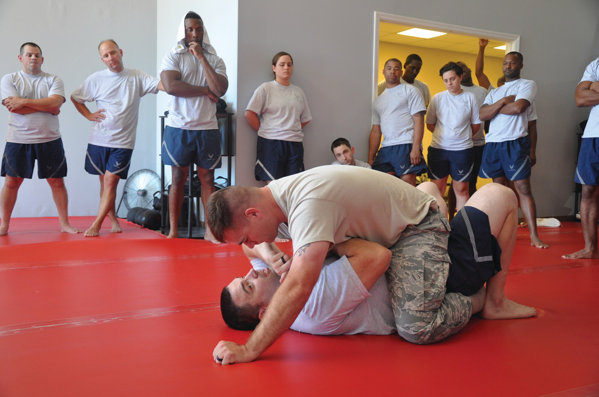 Tech Sgt. Johnny Bowen (bottom) shows how to gain control of an opponent during a grappling training exercise held at the Hot Box in Wetumpka, Ala.