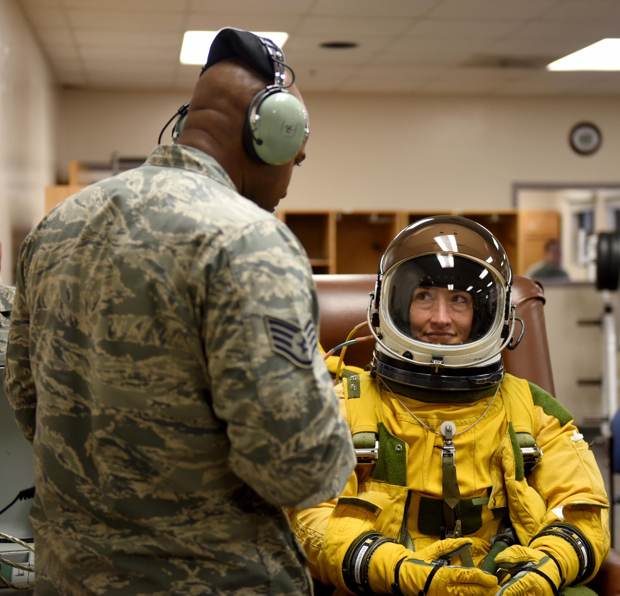Staff Sgt. Reginald Randolph, 9th Physiological Support Squadron aerospace physiology technician, speaks with Christina Koch, NASA astronaut, regarding her experience in a full-pressure suit July 7, 2016, at Beale Air Force Base, California. Koch is undergoing Space Flight Readiness Training. (U.S. Air Force photo/ Senior Airman Bobby Cummings)