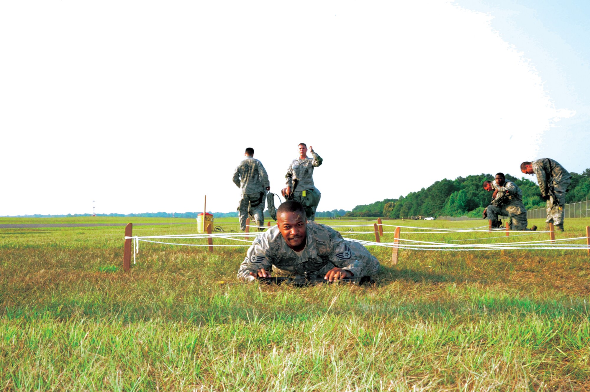 Staff Sgt. Brandon Williams, 908th Security Forces Squadron, crawls under a rope obstacle during a team building exercise.