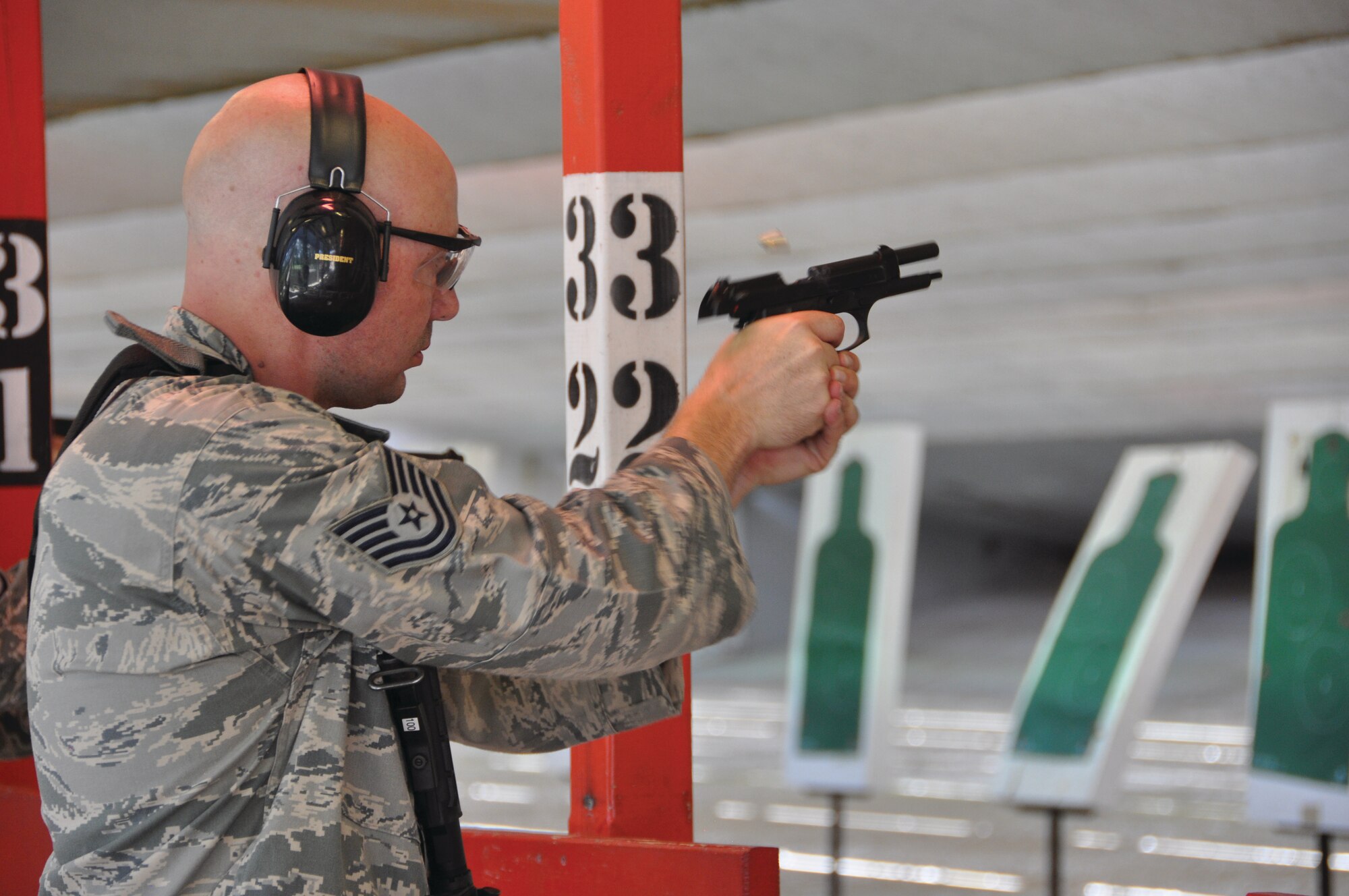 Tech Sgt. James Kenly, 908th Security Forces Squadron, fires a 9 mm pistol during weapons training.