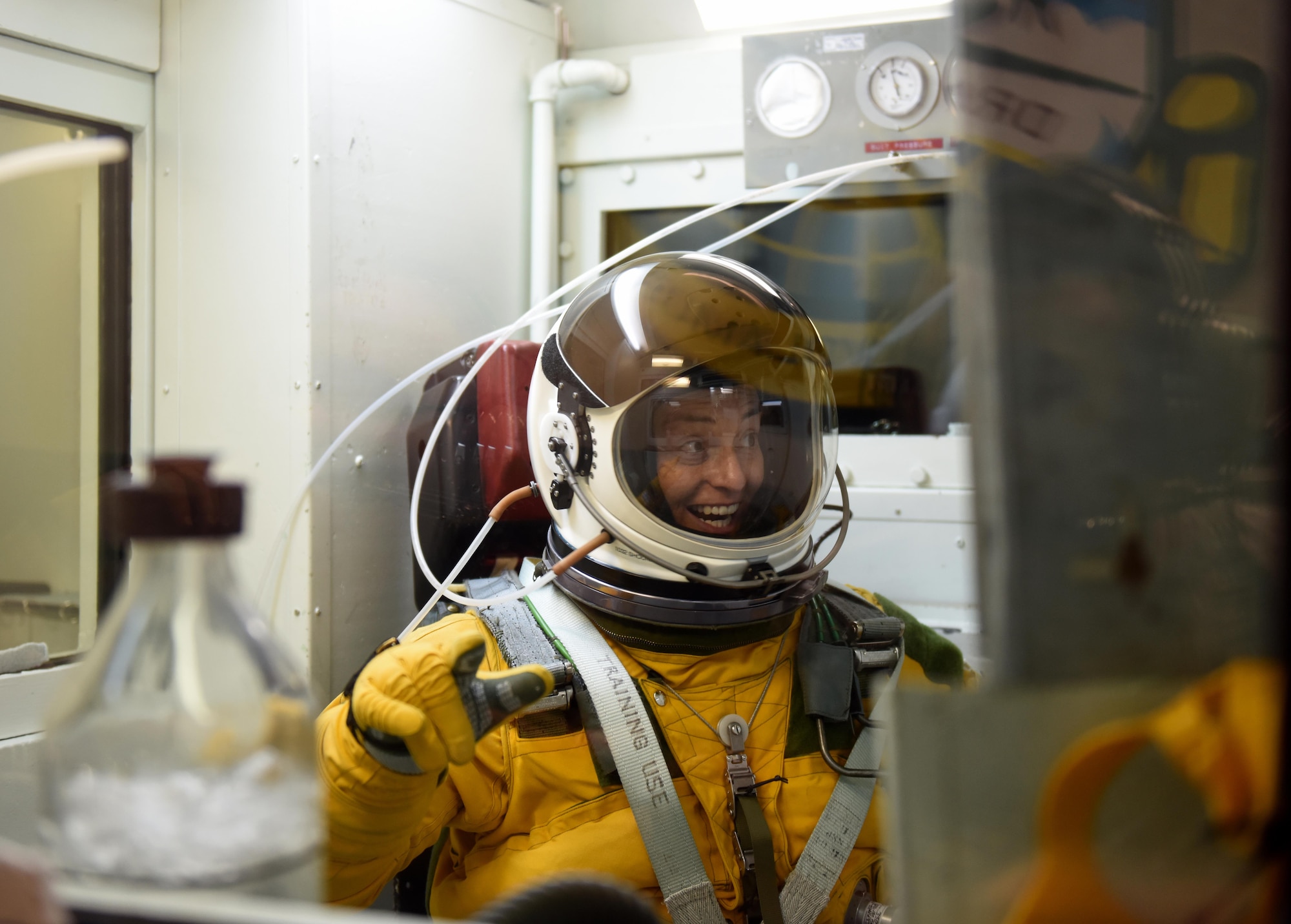 Lt. Col. Nicole Mann, United States Marine Corps, NASA astronaut, reacts to boiling water inside a hypobaric chamber July 7, 2016, at Beale Air Force Base, California. Mann reached simulated altitudes exceeding Armstrong’s line (63,000 ft.) in the chamber. Atmospheric pressure at Armstrong’s line is so low water boils at the normal temperature of the human body. (U.S. Air Force photo/ Senior Airman Bobby Cummings)