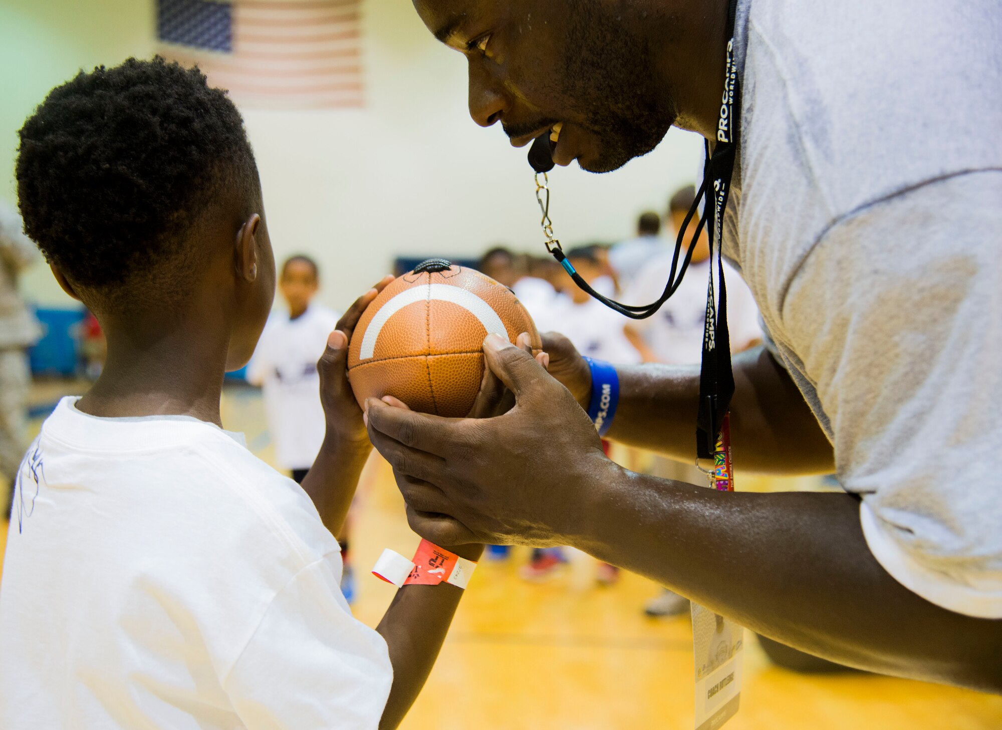 Ronni Rutlegde, Pro Camp Worldwide football coach, runs quarterback drills for the youth during the Steve Smith Pro Camp event July 6, 2016 at Scott Air Force Base, Ill. Steve Smith is a wide receiver for the Baltimore Ravens football team and has participated in 11 Pro Camp events on military bases across the world. The Pro Camp event included offensive, defensive and quarterback drills for the youth of Scott AFB. (U.S. Air Force Photo by Airman Daniel Garcia)