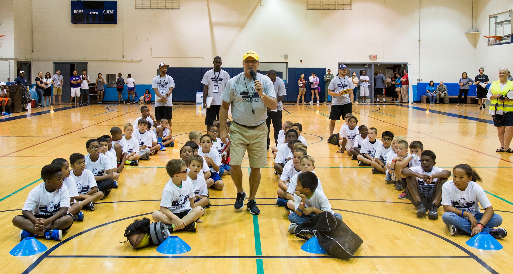 Rod Huber, head football coach at Mount St. Joseph University, instructs children participating in the Steve Smith Pro Camp at Scott Air Force Base, Ill., July 6, 2016. Huber has participated in approximately 20 pro-camps on military bases and has worked with Steve Smith, Balitmore Ravens wide receiver, for 9 years. The Pro Camp event included offensive, defensive and quarterback drills for the youth of Scott AFB. (U.S. Air Force Photo by Airman Daniel Garcia)  (U.S. Air Force Photo by Airman Daniel Garcia)